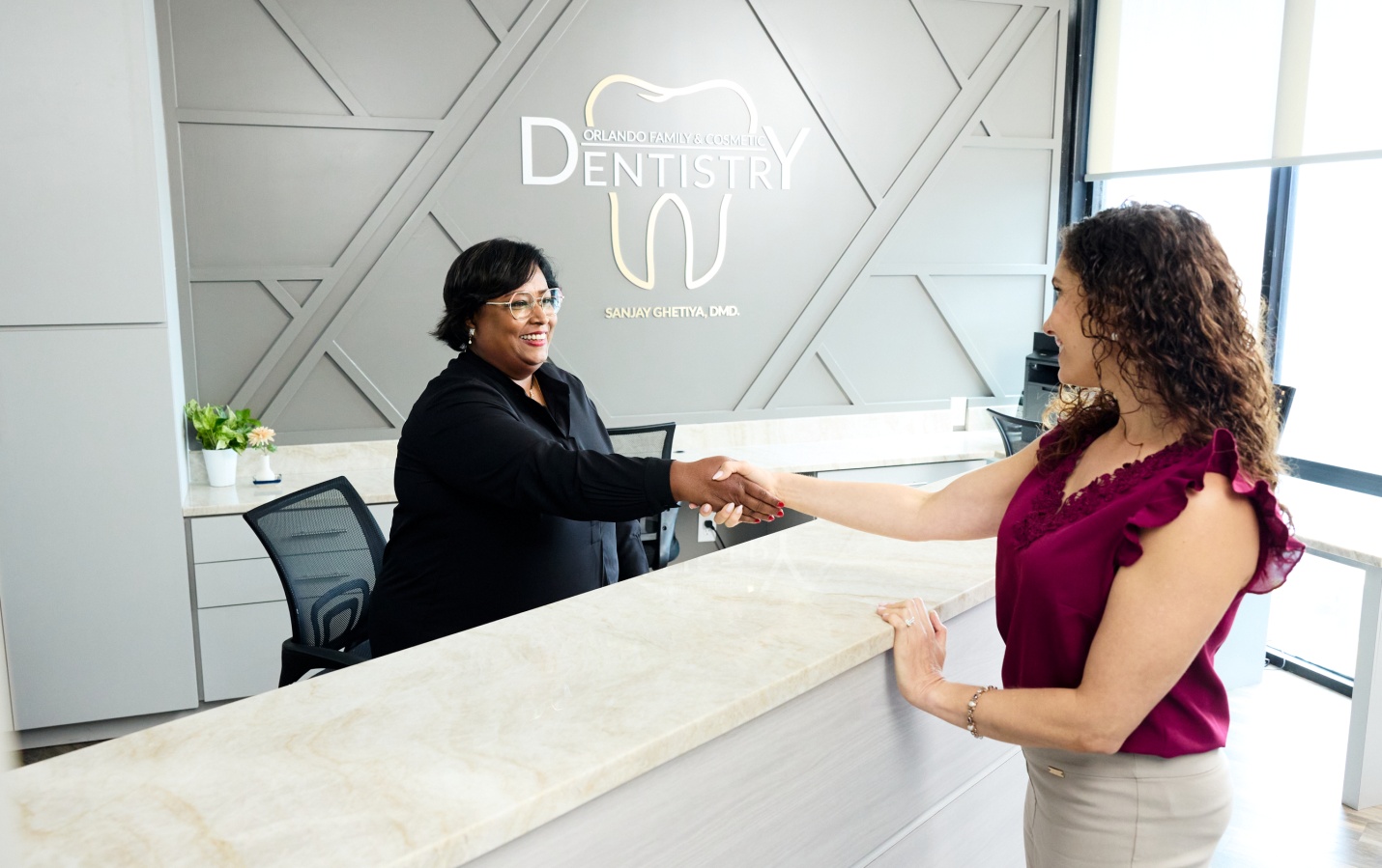 Front desk team member greeting a patient at Orlando Family and Cosmetic Dentistry
